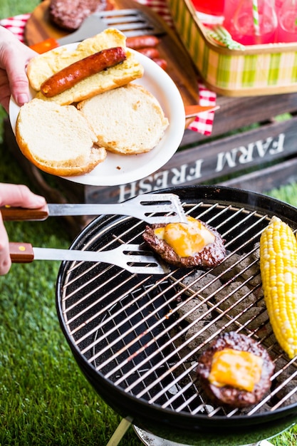 Summer picnic with small charcoal grill in the park.