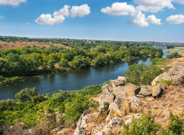 Summer Pivdennyi Buh Southern Bug river in Myhiya Mykolayiv Region Ukraine Landscape of the river with rocky coast