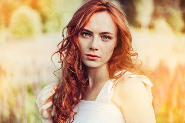 Summer portrait of young sexy ginger girl with freckles on face and body