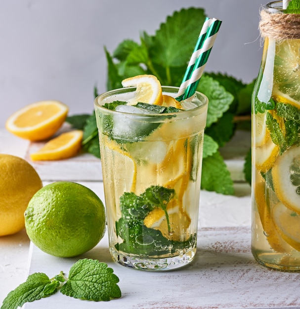 Summer refreshing drink lemonade with lemons, mint leaves, lime in a glass