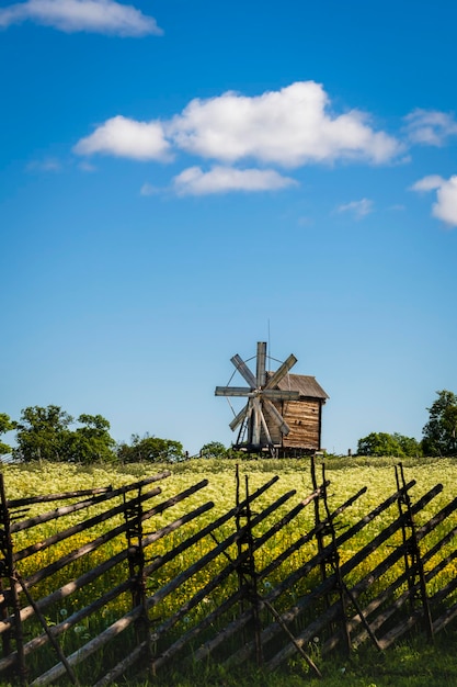 Summer rural landscape behind a wooden fence an old windmill on the island of Kizhi in Karelia