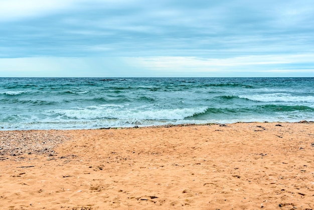 Summer scene with blue sea water white foam and yellow sand with selective focus Vacation or holiday concept Nature background with copy space