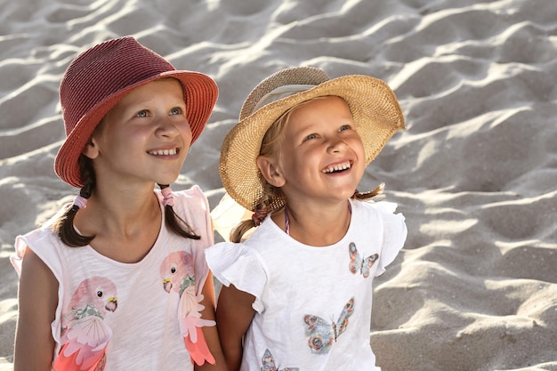 Summer Sea Kids Vacation Happy Beautiful Children looking up in Beach Happy Sea Holiday