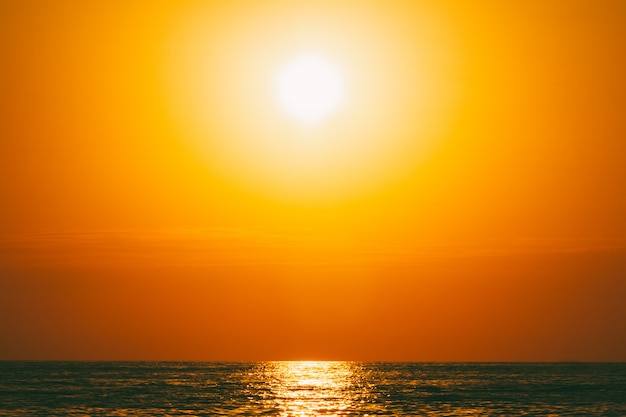 Summer sea landscape with orange sky at sunset