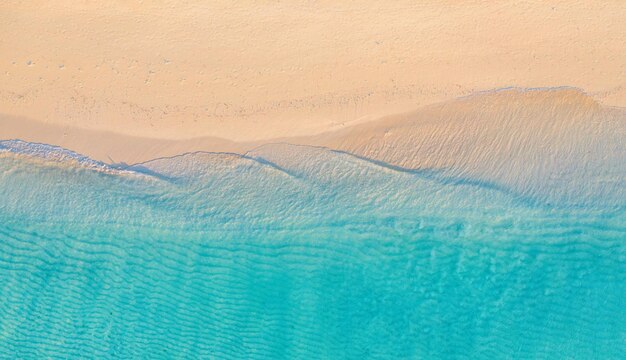 Summer seascape beautiful waves, blue sea water in sunny day. Top drone view. Sea shore aerial view