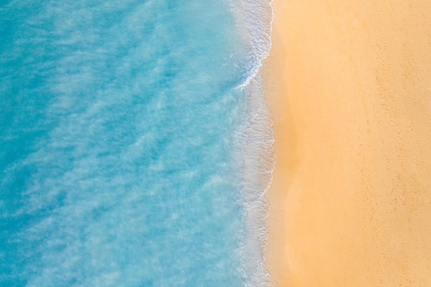 Summer seascape beautiful waves, blue sea water in sunny day. Top view from drone. Sea aerial view,