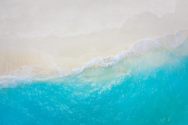 Summer seascape beautiful waves blue sea water in sunny day Top view from drone Sea aerial view