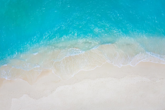 Summer seascape beautiful waves blue sea water in sunny day Top view from drone Sea aerial view