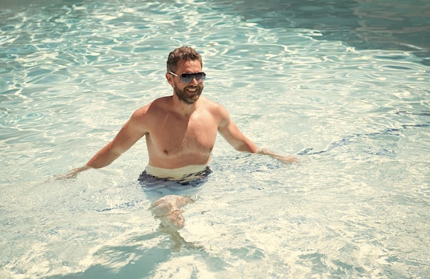 Summer spa resort vacation Happy handsome man in swimming pool Pool party