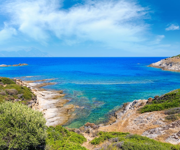 Summer stony sea coast landscape with Atthos mount view in farHalkidiki Sithonia Greece