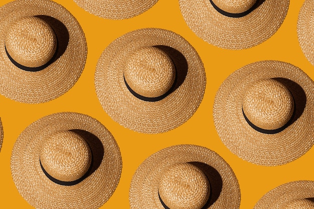 Photo summer straw sun hats with wide brim on orange background