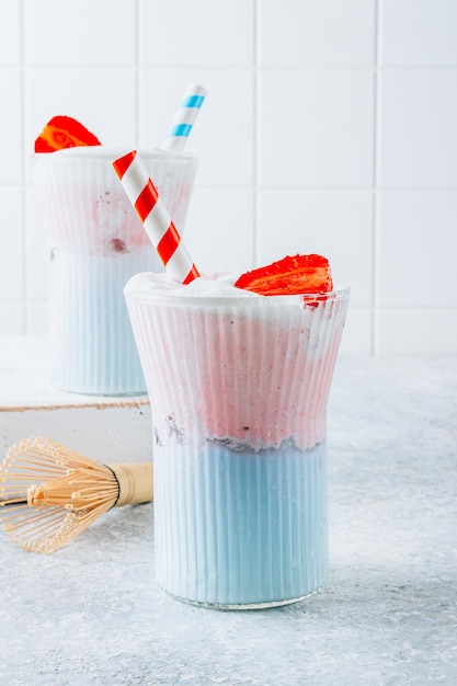 Summer strawberry matcha latte with ice in a glass cup