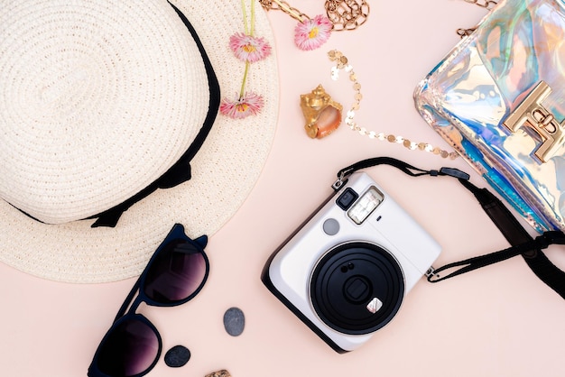 summer travel accessories camera hat glasses and a flat Notepad top view lay flat on a light background