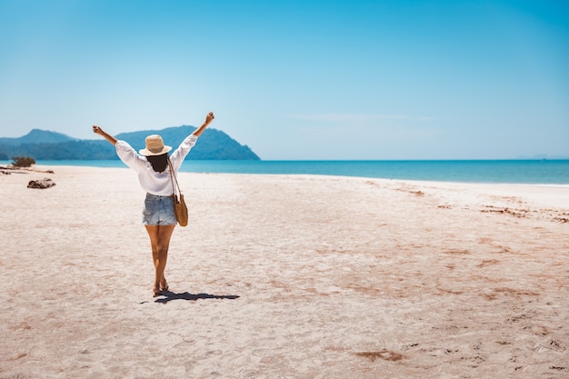 Summer travel vacation concept, Happy traveler asian woman relax and sightseeing on beach in evening at Koh Lipe, Satun, Thailand,