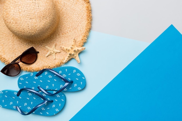 Summer vacation concept flat lay straw hat beach accessories and flip flop top view Space for text travel concept