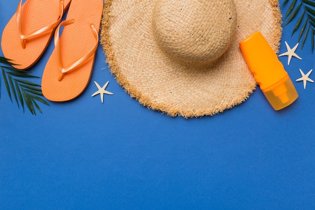 Summer vacation concept flat lay straw hat beach accessories and towel top view Space for text travel concept