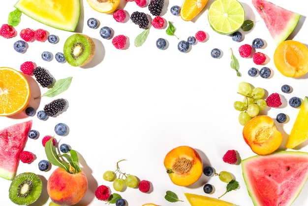 Summer vitamin food concept, various fruit and berries watermelon peach plum apricots blueberry currant, flat lay on white background top view copy