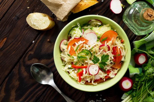 Summer vitamin salad with fresh vegetables dressing olive oil Top view flat lay