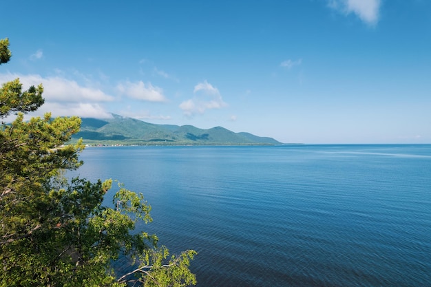 Summertime imagery of Lake Baikal is a rift lake located in southern Siberia, Russia Baikal lake summer landscape view from a cliff near Grandma's Bay. Drone's Eye View.