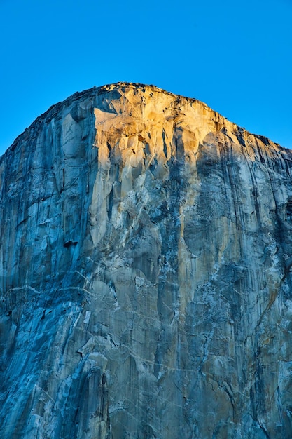 Sun creeping onto the iconic El Capitan cliffs at Yosemite National Park