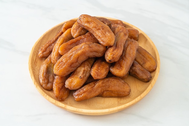 sun dried banana on wooden plate