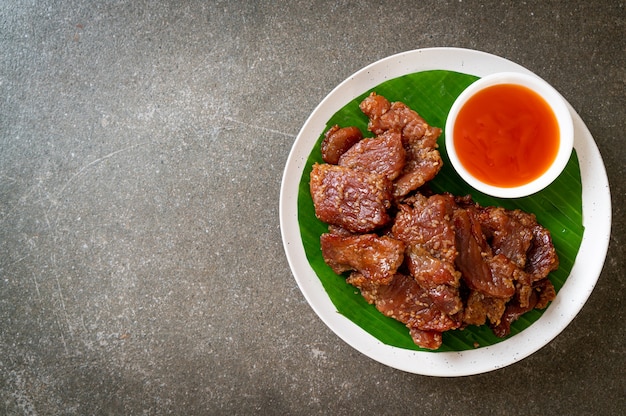 sun dried pork with sauce on plate