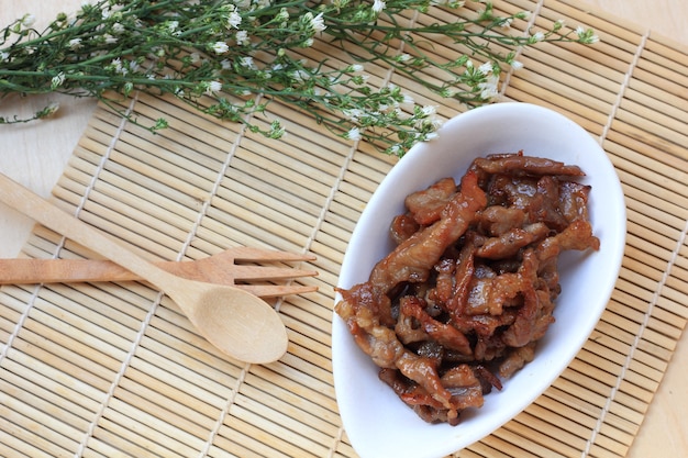  Sun-dried pork on wood background.