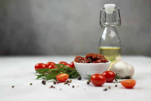 Sun dried tomatoes with fresh herbs spices tomatoes and garlik on the wooden Top view