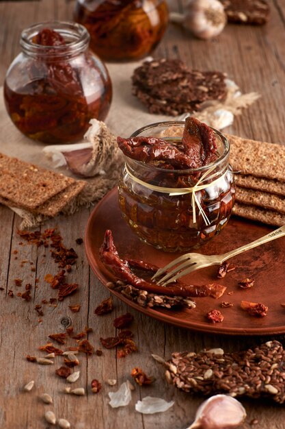 Sun-dried tomatoes with olive oil in a jar of rye bread and a chapel