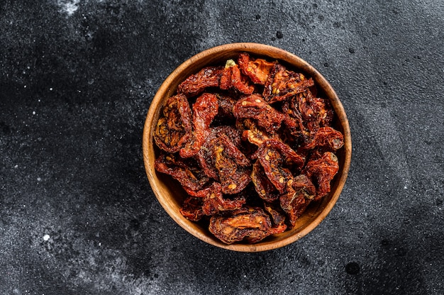 Sun dried tomatoes  in wooden bowl