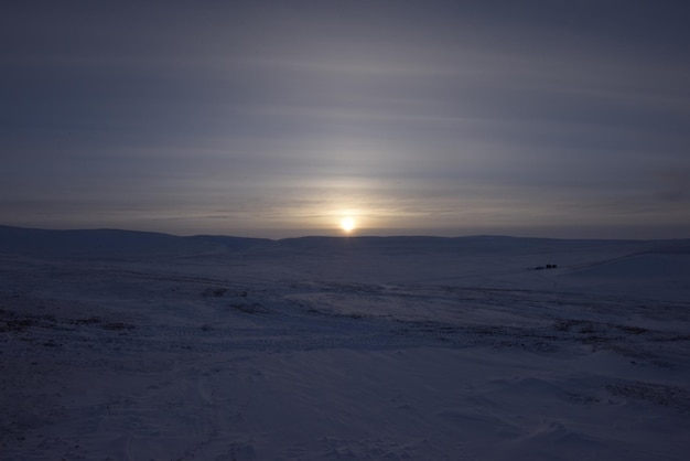 The sun is setting over the arctic.