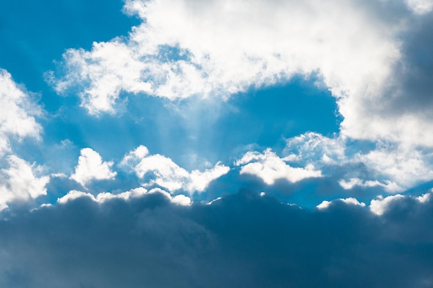 Sun rays behind dark clouds. The sun behind the cloud