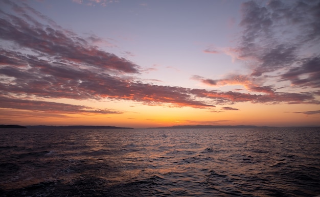 Sun rises over sea waves at early morning