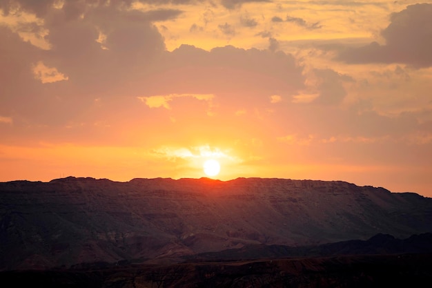 Sun sets behind a mountain in the desert Beautiful sunrise on the top of Mountain South Sinai