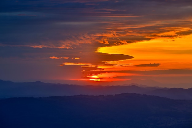 The sun sets in the mountains in Thailand