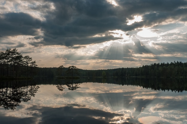 The sun setting over the lake with some interesting clouds in the sky. Sweden