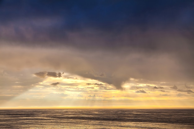 The sunbeam in evening sky and the North Sea