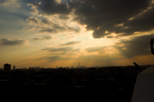 sunbeam through cloud over city below