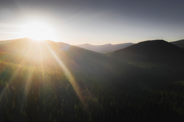 Sunbeam over a top of green mountains