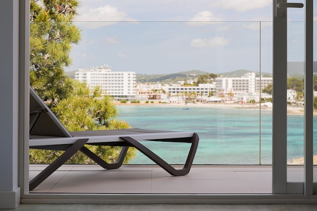 Sunbed on the terrace of an hotel with beautiful view on the sea