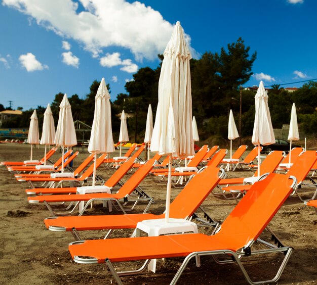 Sunchairs with  umbrellas on beautiful  beach