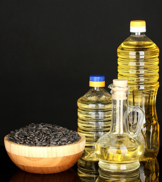 Sunflower oil in bottles isolated on black background