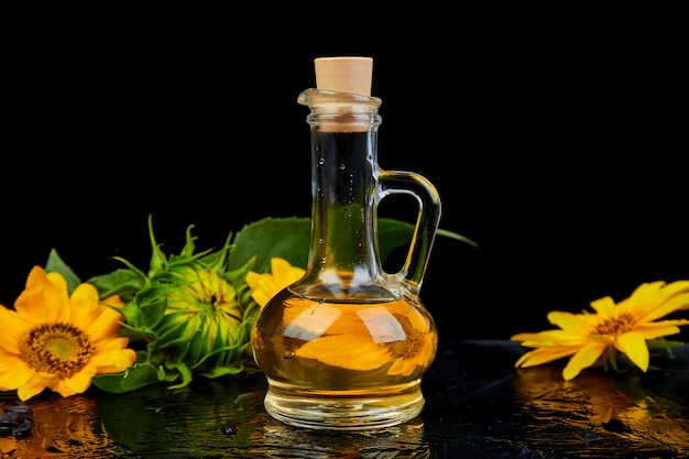 Sunflower oil in glass jar, seeds and flowers