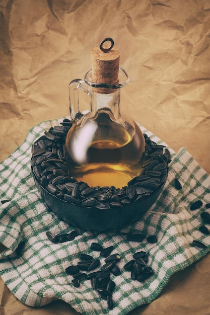 Sunflower oil with a bag of seeds and a wooden spoon