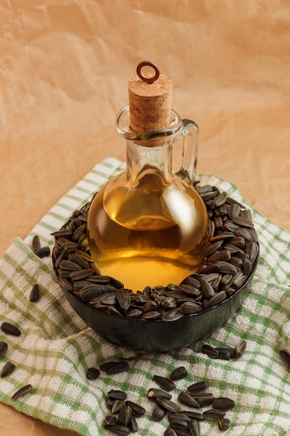 Sunflower oil with a bag of seeds and a wooden spoon