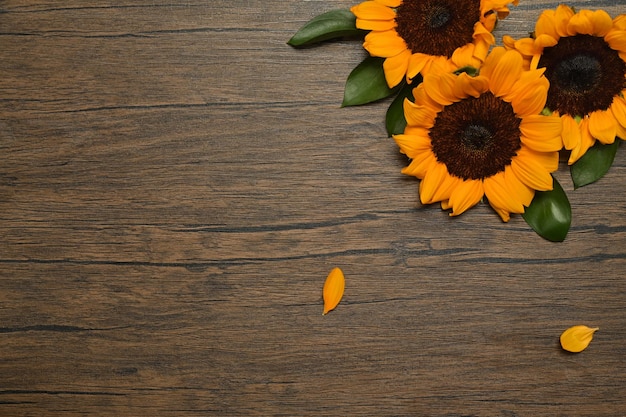 Sunflowers on rustic wooden background Top view with copy space floral background