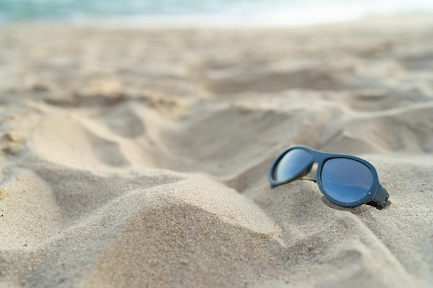 Sunglasses on the beach for vacation concept or for summer background