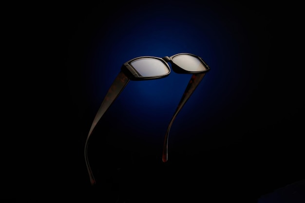 Sunglasses on black and blue background