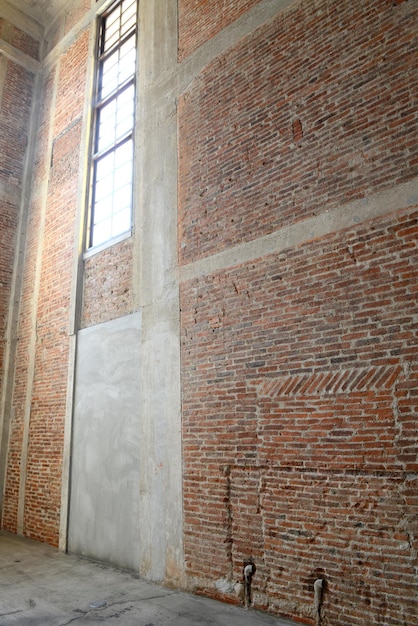 Sunlight from window on the brick walls inside of old building