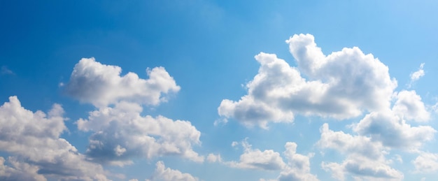 Sunlit white clouds in the blue sky